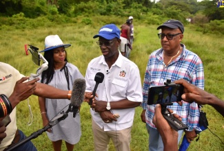Minister of Local Government and Rural Development, Hon. Desmond McKenzie, speaks with journalists following a tour of the Cheswick community in St Thomas, on August 30. The community is next to benefit from a series of upgrades under the Rural Development Programme. Listening to the Minister (from left) are Member of Parliament, St. Thomas Eastern, Dr. Michelle Charles and Councillor for the Dalvey Division, Michael McLeod.