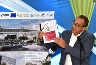 Minister of Health and Wellness, Dr. the Hon. Christopher Tufton, displays the voluminous tender document for the Spanish Town Hospital redevelopment project in St. Catherine. He was addressing a ceremony to officially launch the tender process at the Ministry’s New Kingston offices on Thursday (August 4).

