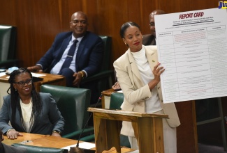 Member of Parliament for Manchester Central, Rhoda Moy Crawford, displays her ‘report card’ during her contribution to the 2022/23 State of the Constituency Debate in the House of Representatives, on September 20.