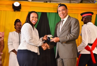 Prime Minister, the Most Hon. Andrew Holness, presents Acting Chief Education Officer, Dr. Kasan Tameka Martin Troupe, with the Prime Minister’s Medal of Appreciation for Service to Education, at Thursday’s (September 8) presentation ceremony at Jamaica House. 