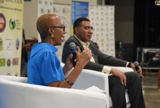 Prime Minister, the Most Hon. Andrew Holness (right), listens as Minister of Education and Youth, Hon. Fayval Williams, responds to a question during a recent townhall meeting on education, which was held at Jamaica College in St. Andrew.