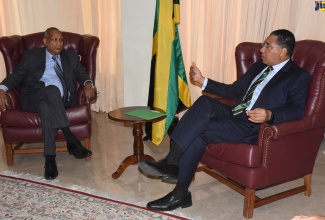 Prime Minister, the Most. Hon. Andrew Holness (right), makes a point to Howard Shearer, son of late Jamaican Prime Minister, the Most Hon. Hugh Shearer, during a courtesy call at the Office of the Prime Minister on September 12.