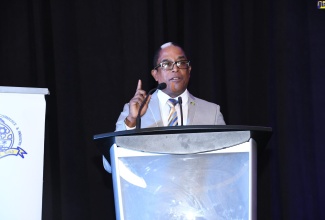 Minister of State in the Ministry of Industry, Investment and Commerce, Dr. the Hon. Norman Dunn, addresses the Montego Bay Chamber of Commerce and Industry (MBCCI) Workforce Readiness Forum, which was held on Thursday (September 22) at Secrets Resort in St. James.