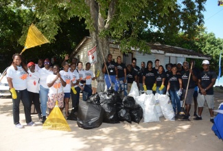 Representatives from the St. Ann Hi-Tech Farmer’s Group, the Jamaica Civil Service Association (JCSA), Red Cross and Bahia Principe display bags of garbage collected from the Red Cross Beach in Discovery Bay, St. Ann, during International Coastal Clean-up Day (ICC) on Saturday, September 17. 