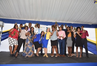 Recipients of the NCB Foundation 2022 Tertiary Scholarship and Grant Programme, with Chief Executive Officer of the NCB Foundation, Nadeen Matthews Blair (front, 3rd left) and Chair of the NCB Foundation, Thalia Lyn (centre ). The presentation ceremony was held on September 2, at the NCB Wellness and Recreation Centre.