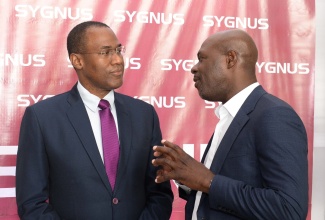 Minister of Finance and the Public Service, Dr. the Hon. Nigel Clarke (left), converses with Chief Executive Officer and President of Sygnus Capital, Beris Grey, during the inaugural ‘Sygnus Day’, held at the AC Hotel Kingston, on Thursday (September 22).