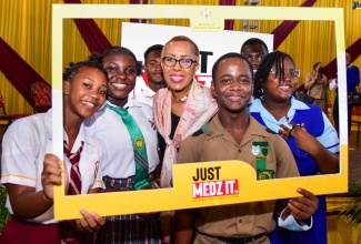 Education and Youth Minister, Hon. Fayval Williams (third left), engages with students from Denham Town, Calabar, and Gaynstead High Schools. The event was the launch of the Ministry’s violence prevention initiative, ‘Just Medz It’, on Wednesday (October 19), at Wolmer’s Boys’ School in Kingston.