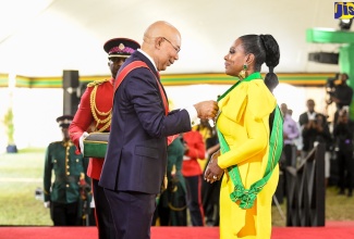 Governor-General, His Excellency, the Most Hon. Sir Patrick Allen (centre), presents actress and cultural ambassador, Sheryl Lee Ralph, with the Order of Jamaica (OJ) during the 2022 Ceremony of Investiture and Presentation of National Honours and Awards at King’s House in Kingston on Monday, (October 17).