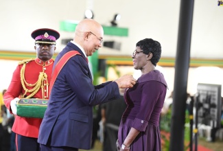 Governor General, His Excellency the Most Hon. Sir Patrick Allen, presents Ivy May Elta Hill with the Badge of Honour for Long and Faithful Service for outstanding contribution to Politics and Community Development (BH{L}). She was among 221 Jamaicans recognised for contribution to national development at the National Honours and Awards ceremony held at King’s House.