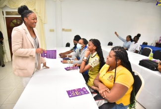 Jamaica Constabulary Force (JCF) Cyber Safety Unit representative, Corporal Samantha Ewan (left), speaks with student teachers from Shortwood Teachers College in Kingston (from third left) Janelle Notice, Ashley Isaacs and Chevonese Wallace, during the opening ceremony for the Child Protection and Family Services Agency’s (CPFSA) anti-bullying workshop, on Thursday (October 13). The ceremony was held at the Medallion Hall Hotel in Kingston, while the workshop sessions were hosted online.