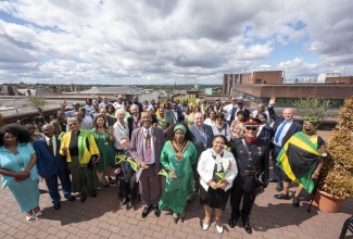 Jamaican-born Mayor of Wolverhampton, United Kingdom (UK), Councillor Sandra Samuels (second left), her husband, Karl (left), and other persons celebrate the 60th Anniversary of Jamaica’s Independence, at the African Caribbean Centre (The Hub) in Wolverhampton,  on August 6, 2022.