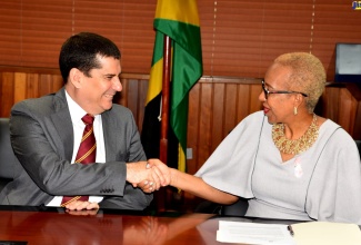 Minister of Education and Youth, Hon. Fayval Williams (right), welcomes  Ambassador of the Republic of Cuba to Jamaica, 
His Excellency Fermin Quiñones Sánchez, during a courtesy call at the Ministry’s office in Kingston, on Wednesday (October 5). 
