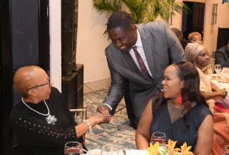 Minister of Education and Youth, Hon. Fayval Williams (left), greets Camperdown Alumni President, Wavell Hinds (centre), during that body’s Gala Dinner at The Jamaica Pegasus hotel in New Kingston on October 22. At right is Acting Chief Education Officer, Ministry of Education and Youth, Dr. Kasan Troupe.