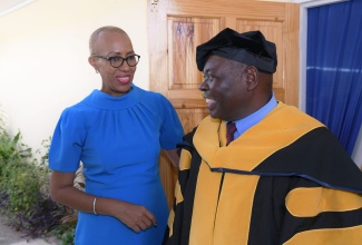 Minister of Education and Youth, Hon. Fayval Williams (left), having a light dialogue with Executive Dean, Caribbean School of Medical Sciences, Jamaica, Dr. Neville Graham, before the start of a graduation ceremony, held at the Marjorie Myers Hall, Shortwood Teachers’ College, on October 30.