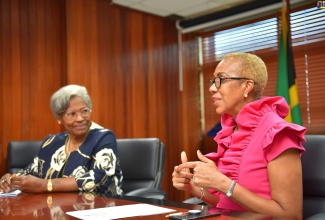 Minister of Education and Youth, Hon. Fayval Williams (right), emphasises a point in discussion with Founding Chief Executive Officer for the Ontario Literacy and Numeracy Secretariat and former Ontario Education Commissioner in Canada, Dr. Avis Glaze, during a courtesy call at the Ministry's offices, in Kingston, on Tuesday (October 18). Dr. Glaze is also a member of the Jamaica Character Education Task Force.