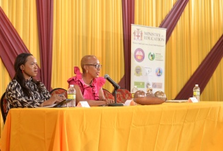 Minister of Education and Youth , Hon Fayval Williams (right), answers questions from students during the Ministry’s National Grooming Policy students’ consultation session at the Wolmer’s Boys’ School in Kingston, on Friday (September 30). Listening is Acting Chief Education Officer, Dr. Kasan Troupe.