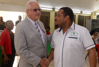 Justice Minister and Member of Parliament for St. Andrew North Eastern, Hon. Delroy Chuck (left), greets Jamaica 4-H Clubs Board Chairman, Collin Virgo, during ‘A Conversation with the Minister’ forum, held at Shortwood Teachers’ College on Tuesday (November 29). The event provided an opportunity for agricultural science and food and nutrition teachers to discuss the national ‘Grow Smart, Eat Smart’ campaign with Agriculture and Fisheries Minister, Hon. Pearnel Charles Jr. 