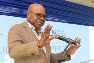 Minister of Tourism, Hon. Edmund Bartlett, addresses the recent launch of the Agricultural Suppliers Food Safety Manual at Devon House in St. Andrew.