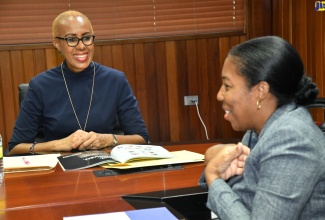 Minister of Education and Youth, Hon. Fayval Williams (left), enjoys a conversation with Director, Future Leaders of Jamaica, Thornia Smith, when the youngster visited the Minister's National Heroes Circle offices in Kingston on November 22. Future Leaders of Jamaica provides scholarships to primary- and secondary-level students in financial need who demonstrate a commitment to learning, community service, and academic excellence.