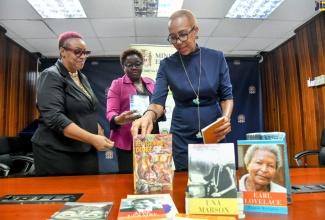 Minister of Education and Youth, Hon. Fayval Williams (right), looks at ‘Revisioning Change’ Case Studies of Curriculum in School Systems in the Commonwealth Caribbean authored by Zellynne Jennings. The book was one of several publications presented to the Minister by representatives of the University of the West Indies (UWI) Press,  at the Ministry in Kingston on Tuesday (November 22).  Looking on (from left) are Marketing and Sales Manager (Acting), UWI Press, Karen Smith; and General Manager (Acting), Nadine Buckland. The oldest and most recognised university press in the Caribbean, UWI Press is a not-for-profit scholarly publisher of more than 500 books and journals in print, audio and electronic formats.