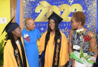 Minister of Education and Youth, Hon. Fayval Williams (second left), congratulates two of Merl Grove’s top-performing students and valedictorians, Natacia Anderson (left) and Racquel Bernard (second right), during the 2022 graduation ceremony held at the institution in Kingston on Sunday (October 30). Sharing the moment is Acting Principal, Lorretta Ricketts. 