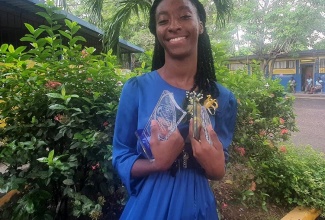 Form Teacher of the Year at the Spanish Town based Jonathan Grant High School in St. Catherine, Krisan Thomas, displays some of her six awards received at the school's recent prizegiving ceremony at the school.