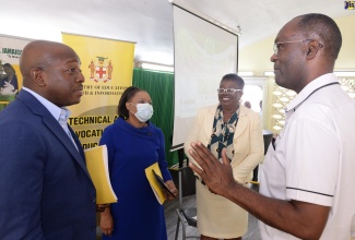 Minister of Agriculture and Fisheries, Hon. Pearnel Charles Jr. (left), converses with Executive Director, Jamaica 4-H Clubs, Dr. Ronald Blake (right). Looking on (from second left) are Deputy Chief Education Officer, Curricula Support Service, Ministry of Education and Youth, Dr. Clover Hamilton-Flowers and Acting Principal, Shortwood Teachers’ College, Dr. Claudette Barrett-March. Occasion was the ‘A Conversation with the Minister’ forum held at the College in St. Andrew, on Tuesday (November 29).