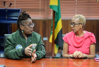 Minister of Education and Youth, Hon. Fayval Williams (right), speaks with Founder and President of the Institute of Caribbean Studies (ICS) in Washington DC, United States and Spirit of Science Mission to Jamaica, Dr. Claire Spence, during a courtesy call at the Ministry in Kingston on December 6. 