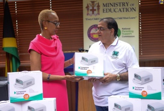 Education and Youth Minister, Hon. Fayval Williams (left), receives a box of compressor nebulisers from Managing Director of appliance and manufacturing company BlackPoint, Gul Mansukhani, at a handover ceremony held at the Ministry’s National Heroes Circle offices, Kingston.