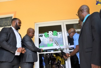 Minister of Agriculture and Fisheries, Hon Pearnel Charles Jr. (third right) cuts the ribbon to officially open the new Rural Agricultural Development Authority (RADA) Office Complex in Lucea, Hanover, on Wednesday (December 14). He is joined by (from left) Parish Board Chairman RADA, Hanover, Lionel Myrie; Minister of State in the Ministry of Agriculture and Fisheries, Hon. Franklin Witter; Mayor of Lucea, Councillor Sheridan Samuels and Acting Chief Executive Officer of RADA, Winston Simpson. 

