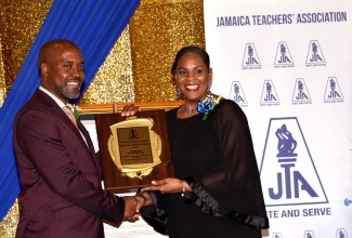 President of the Jamaica Teachers' Association (JTA), La Sonja Harrison (right), presents the JTA Roll of Honour Award to Clayton Hall, during a function held at the AC Hotel Kingston on November 28. The Roll of Honour Award, presented ever year, is the most prestigious award given by the association. It recognises outstanding service to the JTA, education and community (national and international). 