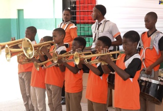 Members of the Tivoli Gardens Drum Corps perform during the ceremony for the official handover of musical instruments, procured through a $2-million grant from the Culture, Health, Arts, Sports, and Education (CHASE) Fund, at the Tivoli Gardens Community Centre in Kingston recently.