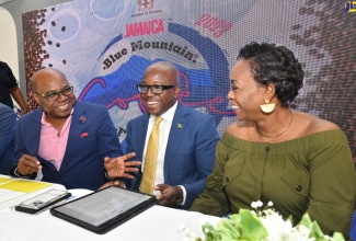 Tourism Minister, Hon. Edmund Bartlett (left), shares a good laugh with Agriculture and Fisheries Minister, Hon.  Pearnel Charles Jr. and Member of Parliament for St. Andrew East Rural, the Most Hon. Juliet Holness, at the launch of the Jamaica Blue Mountain Coffee Festival, at Devon House, on January 9.