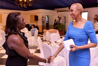 Minister of Education and Youth, Hon. Fayval Williams (right) greets Founder/Director, Jamaica Down’s Syndrome Foundation, Dr. Charmaine Scott at the Foundation's dinner held at the Terra Nova Hotel on January 21.