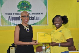 Minister of Education and Youth, Hon. Fayval Williams (left), presents a scholarship certificate to College of Agriculture, Science and Education (CASE) student, Ashli-Ann Graham, during the institution’s Founders’ Weekend Celebration on Saturday (January 28). Minister Williams was the keynote speaker at the event, which was held at the institution’s campus in Portland under the theme: ‘Celebrating our Legacy, Creating Visions of Excellence’.