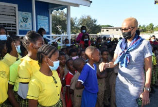 Minister of Education and Youth, Hon. Fayval Williams, interacts with students from the Homestead Primary and Infant School during a visit to the institution in St. Catherine earlier this week. She also met with the members of the administrative staff privately to discuss matters of importance to the school. 