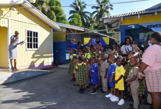 Minister of Education and Youth, Hon. Fayval Williams (left), addresses students during morning devotion at Homestead Primary and Infant School in St. Catherine today (January 24). 