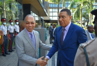 Prime Minister, the Most Hon. Andrew Holness (right), is greeted by Deputy Prime Minister and Minister of National Security, Hon. Dr. Horace Chang, as he arrives for the national security seminar hosted by the Office of the National Security Advisor, at the AC Hotel in Kingston on January 12.