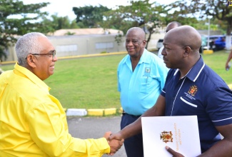 Minister of Agriculture and Fisheries, Hon. Pearnel Charles Jr. (right), is greeted by College of Agriculture, Science and Education (CASE) Alumni Association President, Pius Lacan, on arrival at the institution in Passley Gardens, Portland, on January 27, for an Intellectual Stimulation Day event. The event formed part of the CASE Founders’ Weekend activities, which were organised by the Association in collaboration with the college’s administration. Accompanying Mr. Charles Jr. is State Minister in the Agriculture Ministry, Hon. Franklyn Witter.