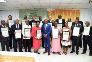 Minister of Agriculture and Fisheries, Hon. Pearnel Charles Jr. (centre, front row) is flanked by recipients of the Agricultural Legacy Awards during the ceremony held on Saturday (January 14) at the Medallion Hall Hotel, Kingston.

