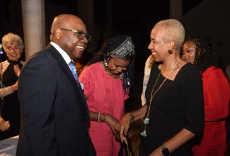 Minister of Tourism, Hon. Edmund Bartlett (left), greets Minister of Education and Youth, Hon. Fayval Williams (right), on arrival at the East Central St. James Education Fund 25th anniversary dinner at the Half Moon Hotel Conference Centre in Montego Bay, on January 14. 