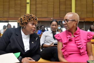 Minister of Education and Youth, Hon. Fayval Williams (right), speaks with President, Jamaica Teachers' Association (JTA), LaSonja Harrison (left) at the Global Education Teacher Summit held at the Jamaica Conference Centre, on January 21. Looking on is Manager, Communication and Public Relations Division in the Ministry of Education and Youth, Sheryl Bromfield.