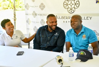 Minister of Agriculture and Fisheries, Hon. Pearnel Charles Jr. (right), shares pleasantries with entrepreneurs, Jeffrey and Nicole Campbell, during a tour of their Mulberry Valley Estate in Friendship Gap, St. Mary, on Thursday (January 26).