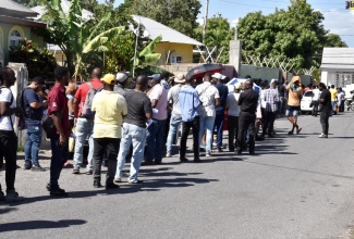 Motorists brave the mid-morning sun outside the Corporate Area Traffic Court on South Camp Road on Tuesday (January 31), in a final effort to settle outstanding traffic tickets ahead of the new Road Traffic Act coming into effect on Wednesday (February 1). The Government had offered motorists with outstanding tickets a reprieve to allow them to pay their fines and have demerits accumulated against their driver’s licences expunged, ahead of the Act taking effect. 