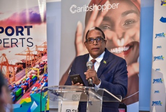 Minister of State in the Ministry of Industry, Investment and Commerce, Dr. the Hon. Norman Dunn, addresses a ceremony for the signing of a Memorandum of Understanding (MoU)  between the Jamaica Manufacturers and Exporters Association (JMEA) and Caribshopper, at Outpost Republic, Lady Musgrave Road on February 23.