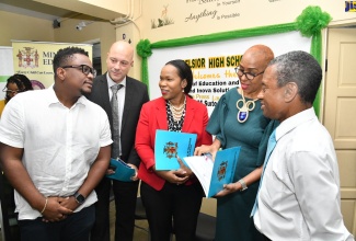 Minister of Education and Youth, Hon. Fayval Williams (second right), listens as Chief Executive Officer of EducFocal Limited, Gordon Swaby (left), speaks to Territory Manager of INOVA Solutions, Jeroen Nederkoorn (second left) and Acting Chief Education Officer, Dr. Kasan Troupe (third right), at the launch of the Microsoft 365 Programmes for teachers and students, at Excelsior High School, today (February 14).  At right is  Principal of  Excelsior High School, Deanroy Bromfield.