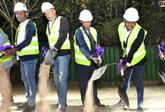 Minister of Industry, Investment and Commerce, Senator the Hon. Aubyn Hill (second right),  participates in the ground-breaking exercise for the FirstRock Real Estate Investments (FREI) $2.5- billion luxury residential development, Bonne Chance, located at 8A Brompton Road, Kingston. The ground-breaking ceremony was held on Thursday (February 23). Also taking part in the exercise are (from left) Head of Real Estate Business, FirstRock Capital Resource (FCR) Limited, Denroy Pusey; Director and Co-Founder, FirstRock Real Estate Investment Limited, Dr. Michael Banbury; and Chairman and Co-Founder, FirstRock Capital Resource Limited, Ryan Reid. 