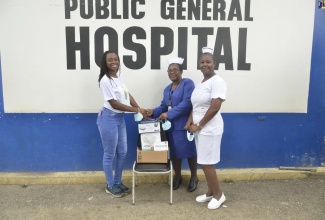 University of Technology (UTech) student, Geri-Ann Miller (left), hands over a donation of three nebulisers to Director of Nursing Services at the Savanna-la-Mar Public General Hospital in Westmoreland, Hazeline Forrester (centre) and Nurse at the facility, Sister Sophia Thomas,  at the hospital on Saturday (February 11). 