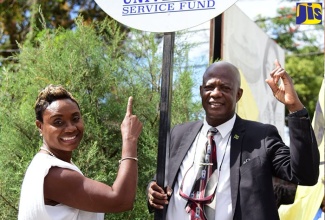 Member of Parliament for St. Andrew West Rural, Hon. Juliet Cuthbert-Flynn and Chief Executive Officer of the Universal Service Fund (USF), Daniel Dawes, celebrate the installation of the free Wi-Fi Hotspot facility in the Lawrence Tavern community in St. Andrew, recently.