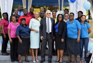 Minister of Education and Youth, Hon. Fayval Williams (third left, foreground); Justice Minister, Hon. Delroy Chuck (centre, foreground) and Acting National Restorative Justice Coordinator, Saccsha Ebanks (third right, foreground), are flanked by members of the Restorative Justice Unit during a restorative justice session with students of the Kingston Technical High School. The session was held at the Hope Botanical Gardens on February 7.